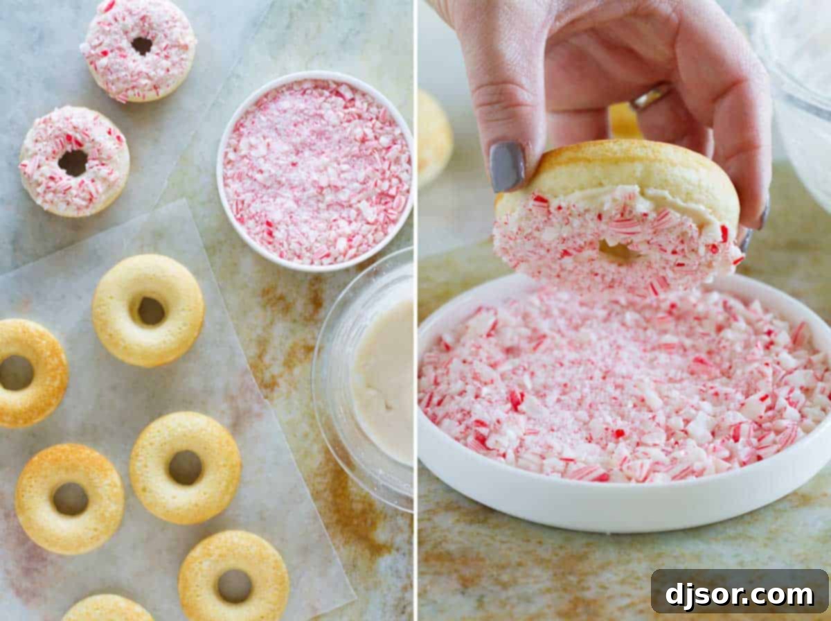 Baked peppermint donuts being dipped in crushed candy canes, showing the preparation process.
