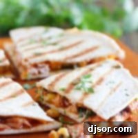 Ultimate Grilled Chicken Quesadillas 2 Grilled Chicken Quesadillas on a cutting board