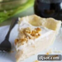 Maple Cream Pie Recipe A perfectly sliced piece of Maple Cream Pie, showcasing its creamy filling, fluffy whipped cream, and crunchy sugared almond topping, resting on a white plate, ready to be enjoyed.