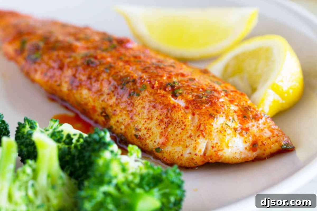 Parmesan Crusted Tilapia fillet served with lemon and fresh broccoli