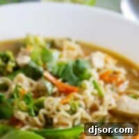 Asian Chicken Noodle Soup in a white bowl on a napkin