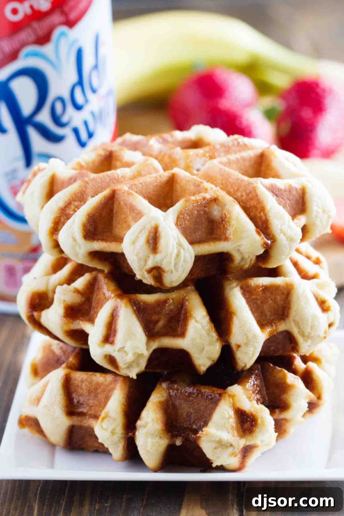 Bring a taste of Belgium into your kitchen with these Liege Waffles! A wonderful special breakfast or afternoon treat, these yeasted sugar waffles are irresistible. A neatly stacked trio of golden-brown Liege waffles on a white plate, ready to be adorned with toppings.