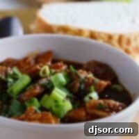 New Mexican Red Pork Chili Recipe Image New Mexican Red Pork Chili: A hearty bowl of chili with tender pork chunks and a rich red sauce.