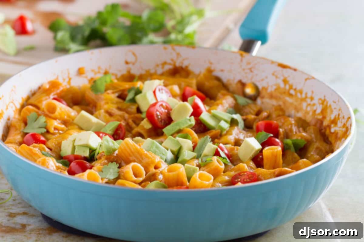 Great flavors come together in one pan in this One Pan Enchilada Pasta. It’s got the Tex-Mex flavors that mom and dad love, while being mild enough for the kids. And there’s only one pan to clean when it’s done! Skillet filled with enchilada pasta - an easy weeknight dinner, garnished with fresh cilantro.