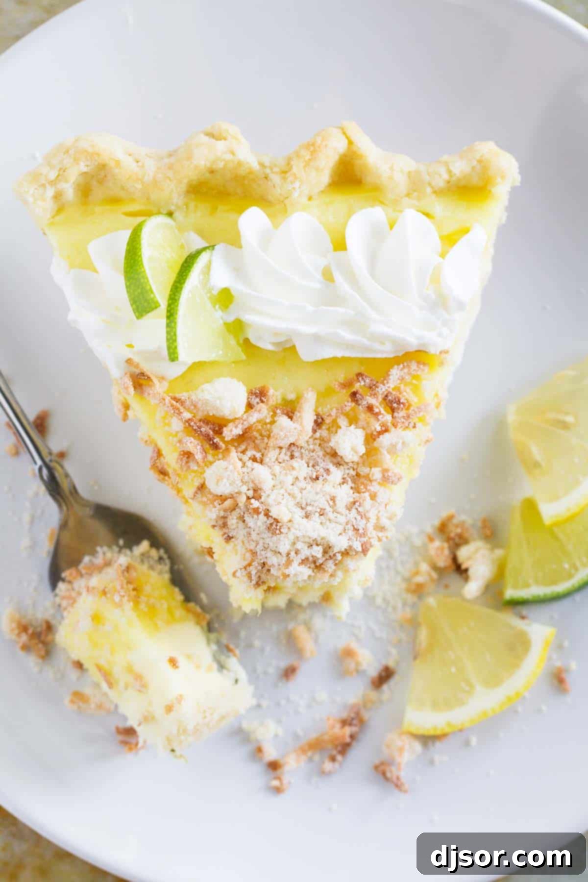 Top view of Caribbean Truffle pie with a bite taken from it, showcasing its creamy filling and toasted coconut topping.