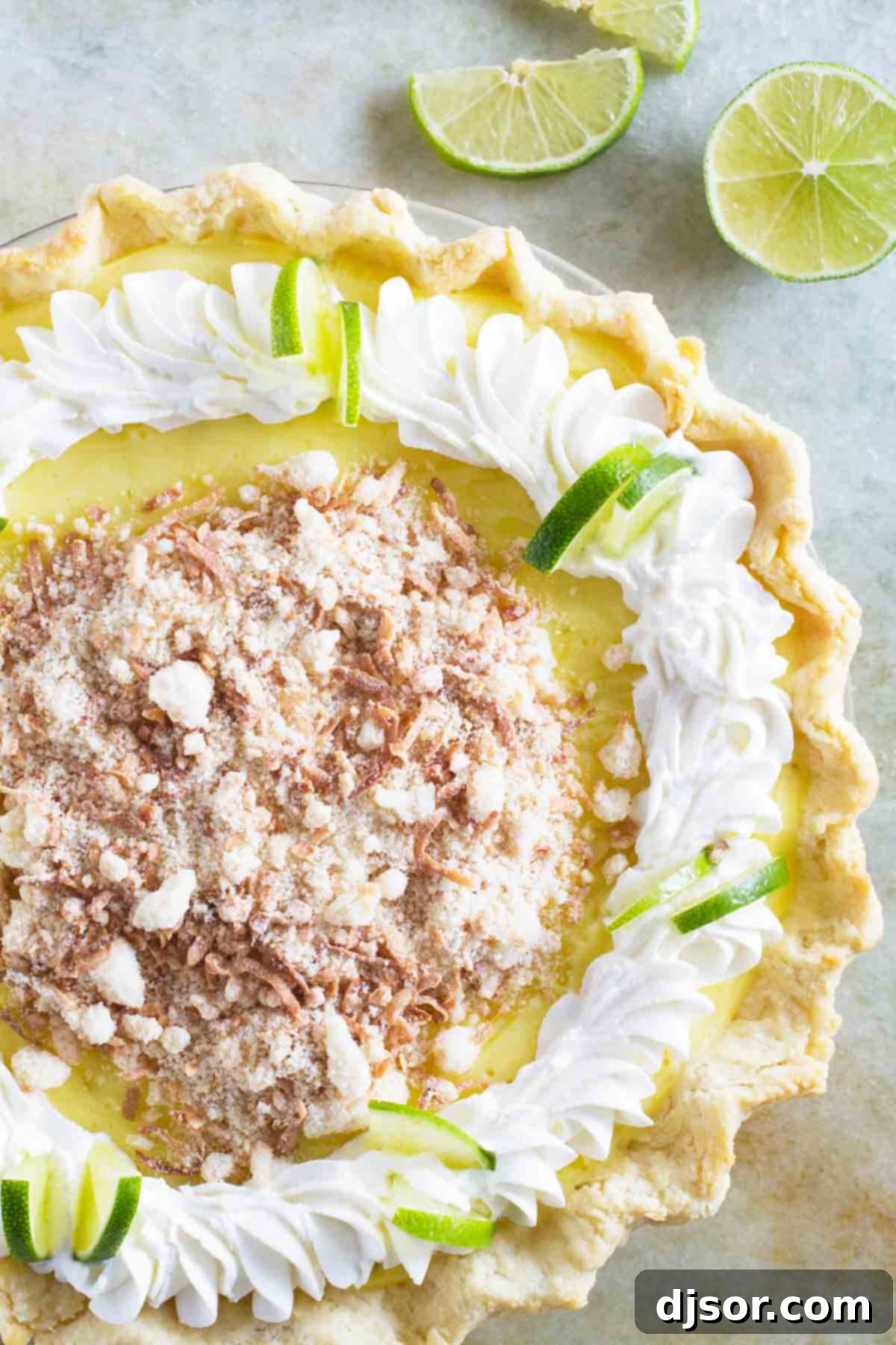 Full Caribbean Truffle Pie topped generously with toasted coconut flakes and delicate swirls of whipped cream, ready to be served.