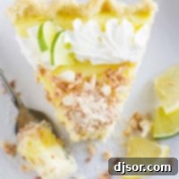 Top view of Caribbean Truffle pie with a bite taken from it, showcasing its creamy filling and toasted coconut topping.