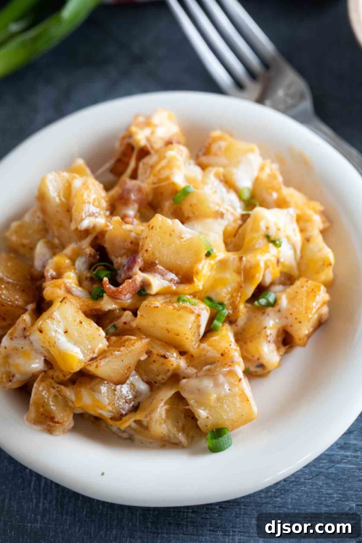 Plate of Cheesy Ranch Potatoes topped with fresh green onions