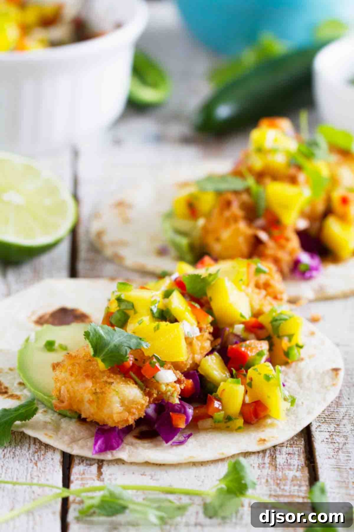 Crispy coconut shrimp arranged on warm flour tortillas, showcasing the beautiful golden-brown crust.