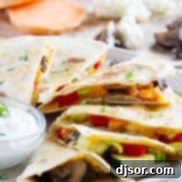Slices of a veggie quesadilla fanned out on a plate, ready to be enjoyed.