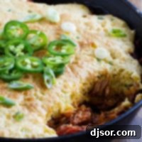 Cornbread-Crusted BBQ Pork Casserole 5 Cornbread Topped BBQ Pork with a scoop taken out.
