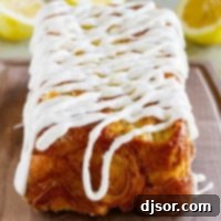 Bright Lemon Swirl Pull-Apart Loaf 9 Loaf of Lemon Roll Pull Apart Bread with icing on top.