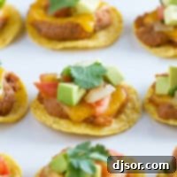Nacho bites topped with cilantro, avocado, and pico de gallo.
