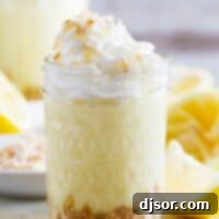 glass jar filled with Coconut Lemon Pudding Parfait topped with whipped cream.