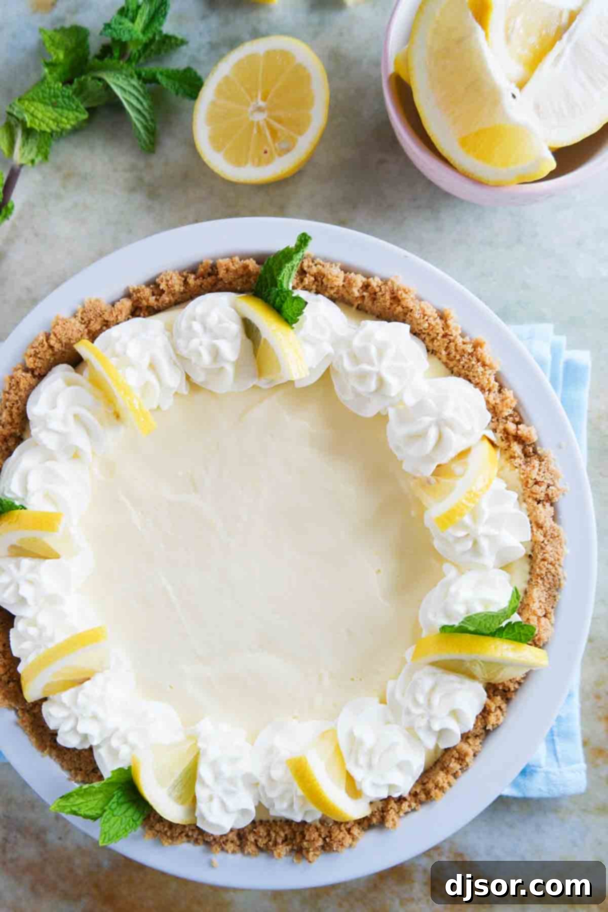 whole lemon cream pie with whipped cream and lemon slices