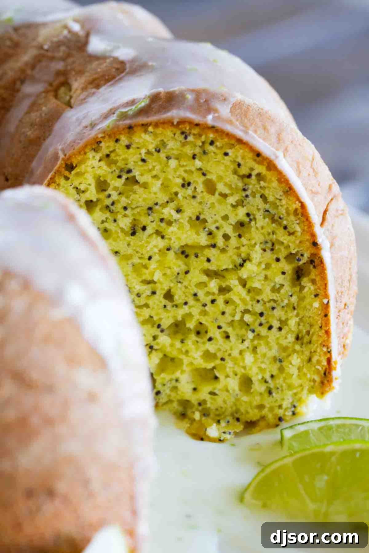 Lime Poppy Seed Cake with a slice taken to show inside of cake