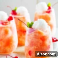 glasses of fruit freeze punch topped with sorbet and cherries