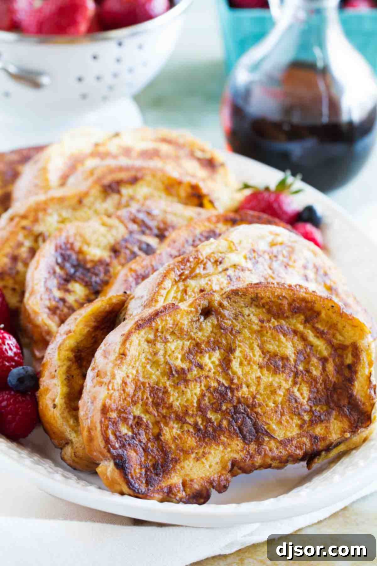 A large platter generously filled with freshly cooked Ice Cream French Toast slices, golden brown and ready to be served.