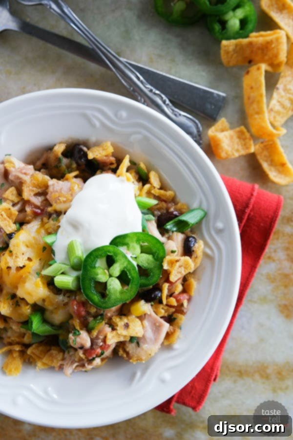 Close-up of the Slow Cooker Cheesy Chicken and Frito Casserole, showcasing melted cheese, tender chicken, and crisp Fritos on top.