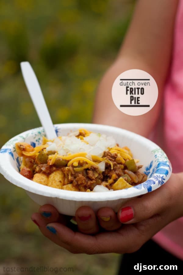 Hearty Dutch Oven Frito Pie, a robust chili recipe topped with crunchy Fritos, ideal for camping or a cozy meal.