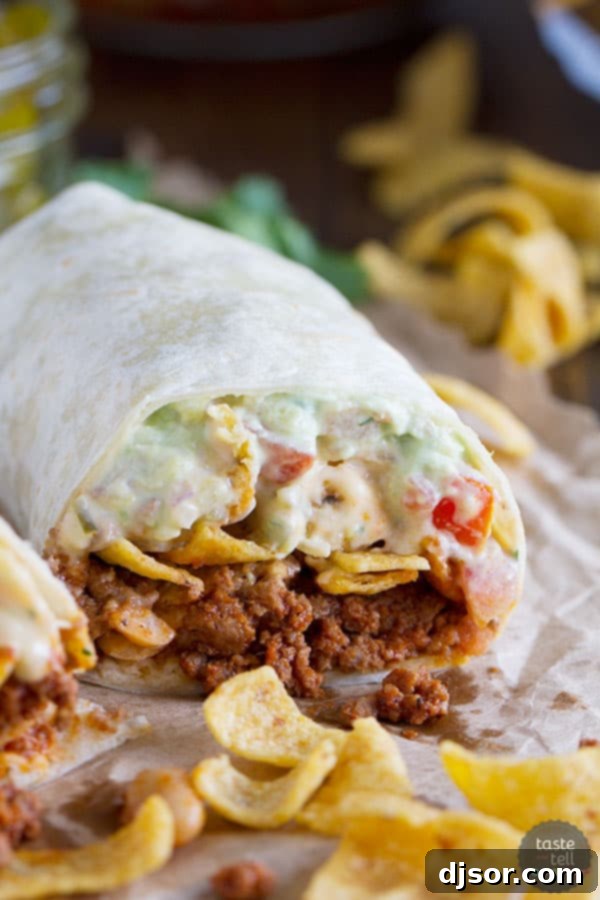 A generously filled Frito Pie Burrito with chili, queso, pico de gallo, avocado cream, and jalapeños.
