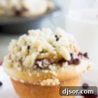 Hero shot of a single Chocolate Cherry Streusel Roll with cherry and chocolate peeking out.