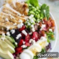 Cobb salad with grilled chicken, tomatoes, eggs, edamame, bacon, and avocado.