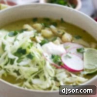 Zesty Green Pozole 10 A vibrant bowl of Pozole Verde, generously topped with crisp shredded cabbage and thinly sliced radishes.