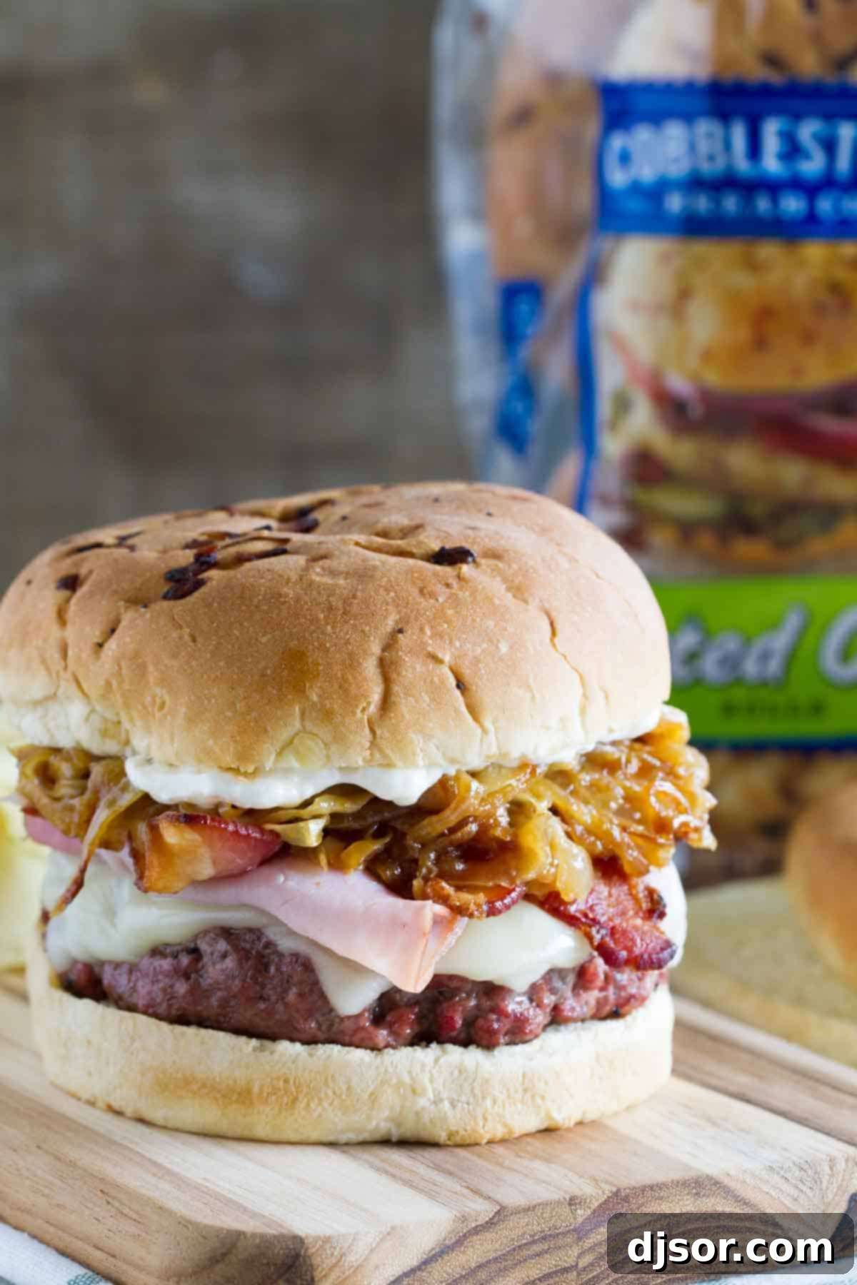 Triple Threat Pork Burger 5 Triple Pork Burgers with ground pork, ham, and bacon on a wooden board.