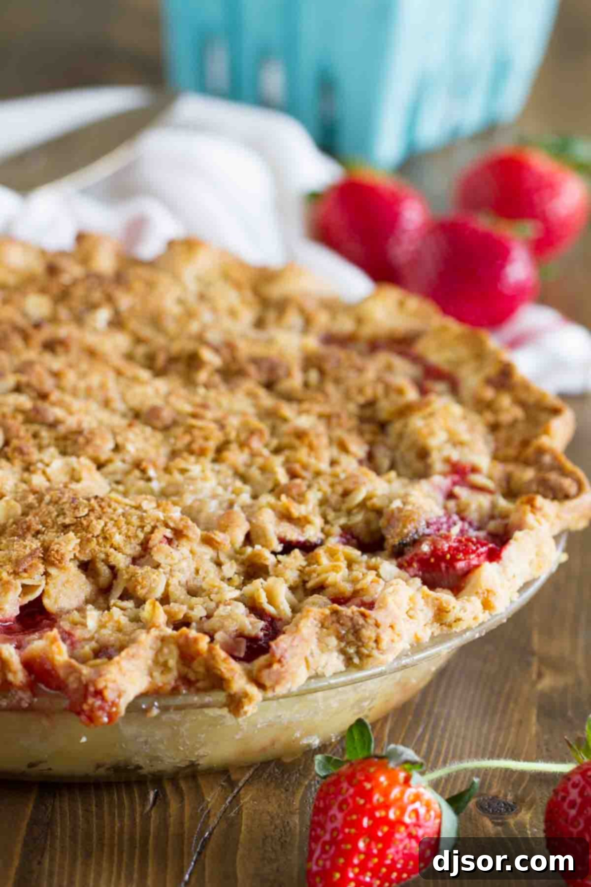 Beautifully baked Strawberry Crumble Pie, showcasing a golden crumble topping and fresh strawberry slices.