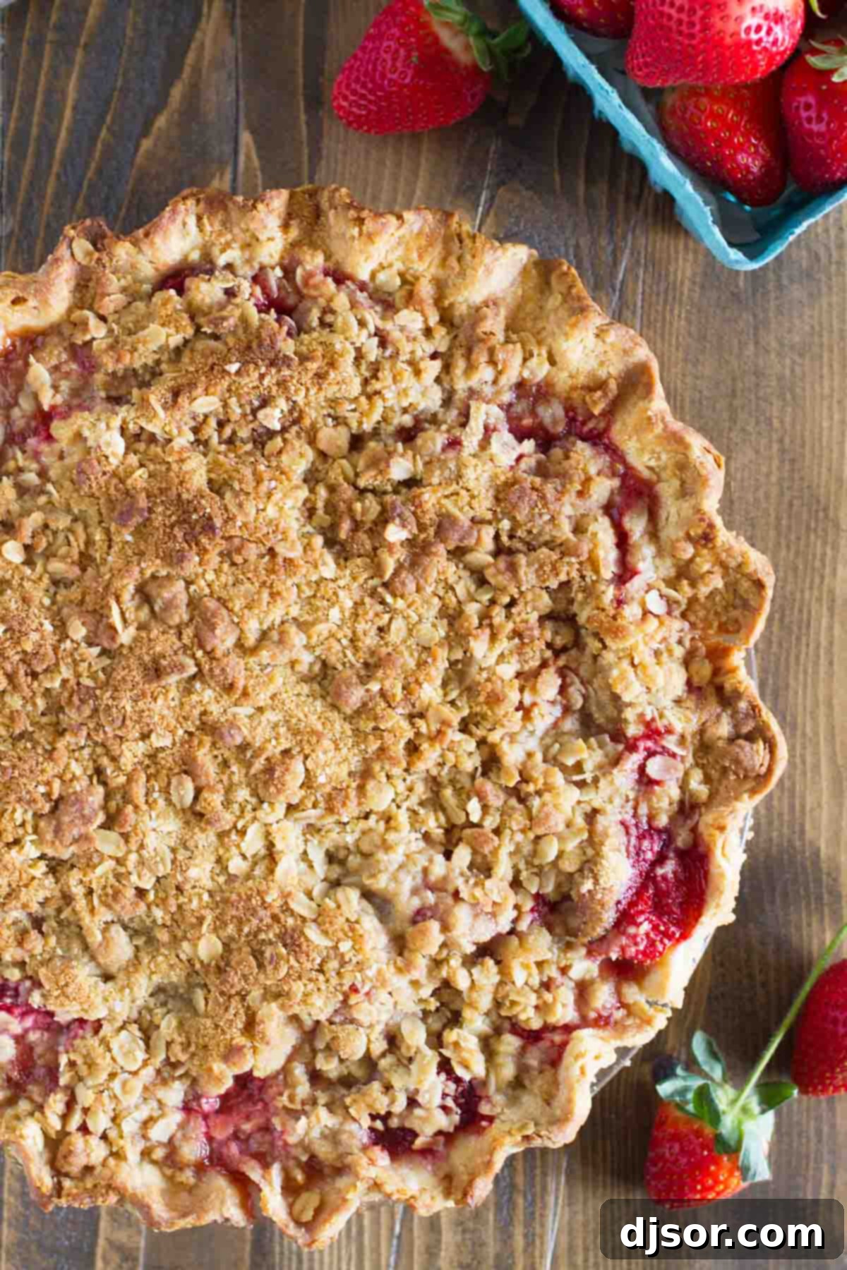 Close-up shot of a Strawberry Crumble Pie, focusing on the textured crumble topping.