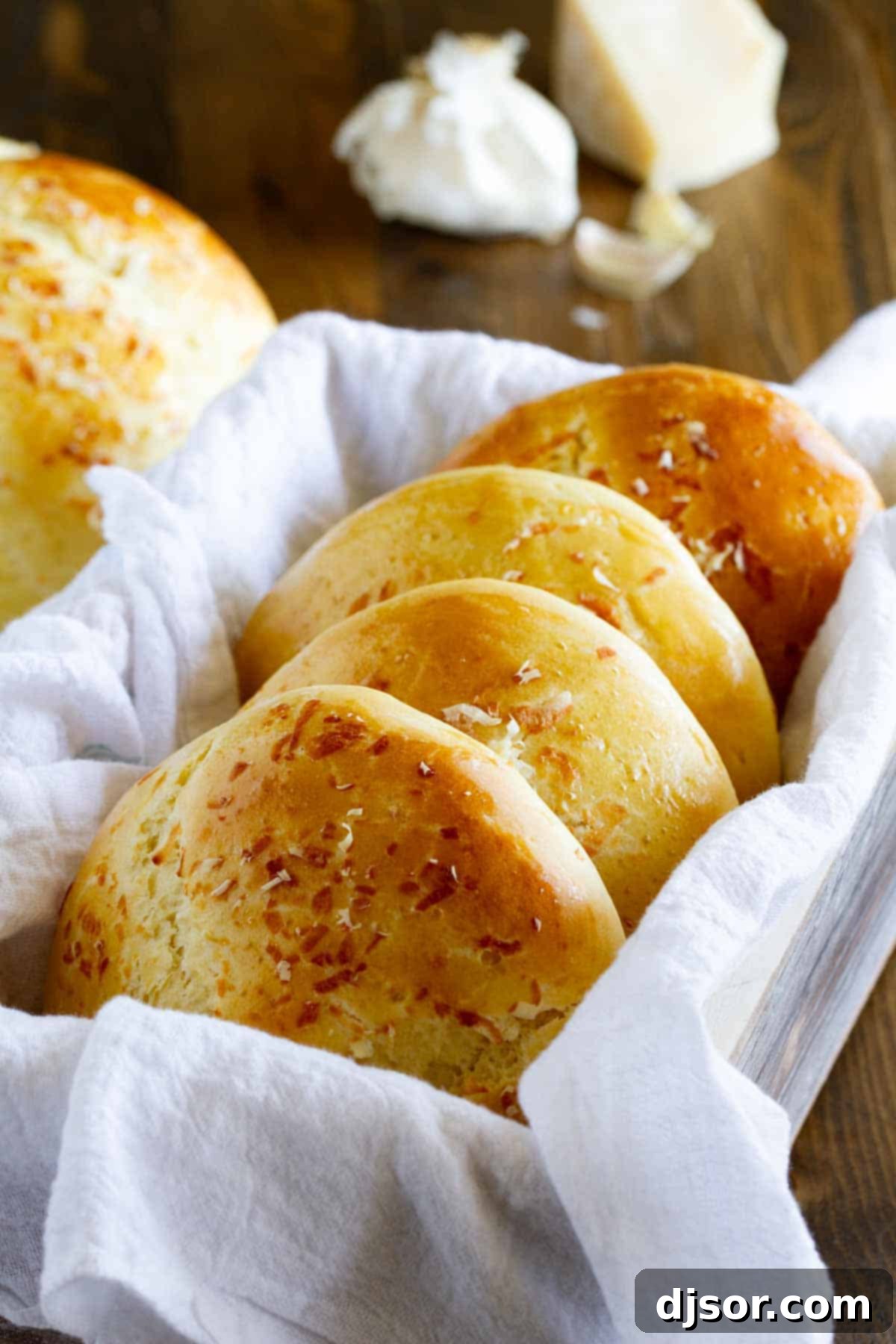 Fluffy Garlic Parmesan Brioche Buns 2 Freshly baked Garlic Parmesan Brioche Buns stacked together, golden brown and inviting.