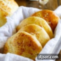 Fluffy Garlic Parmesan Brioche Buns 9 Garlic Parmesan Brioche Buns stacked together.