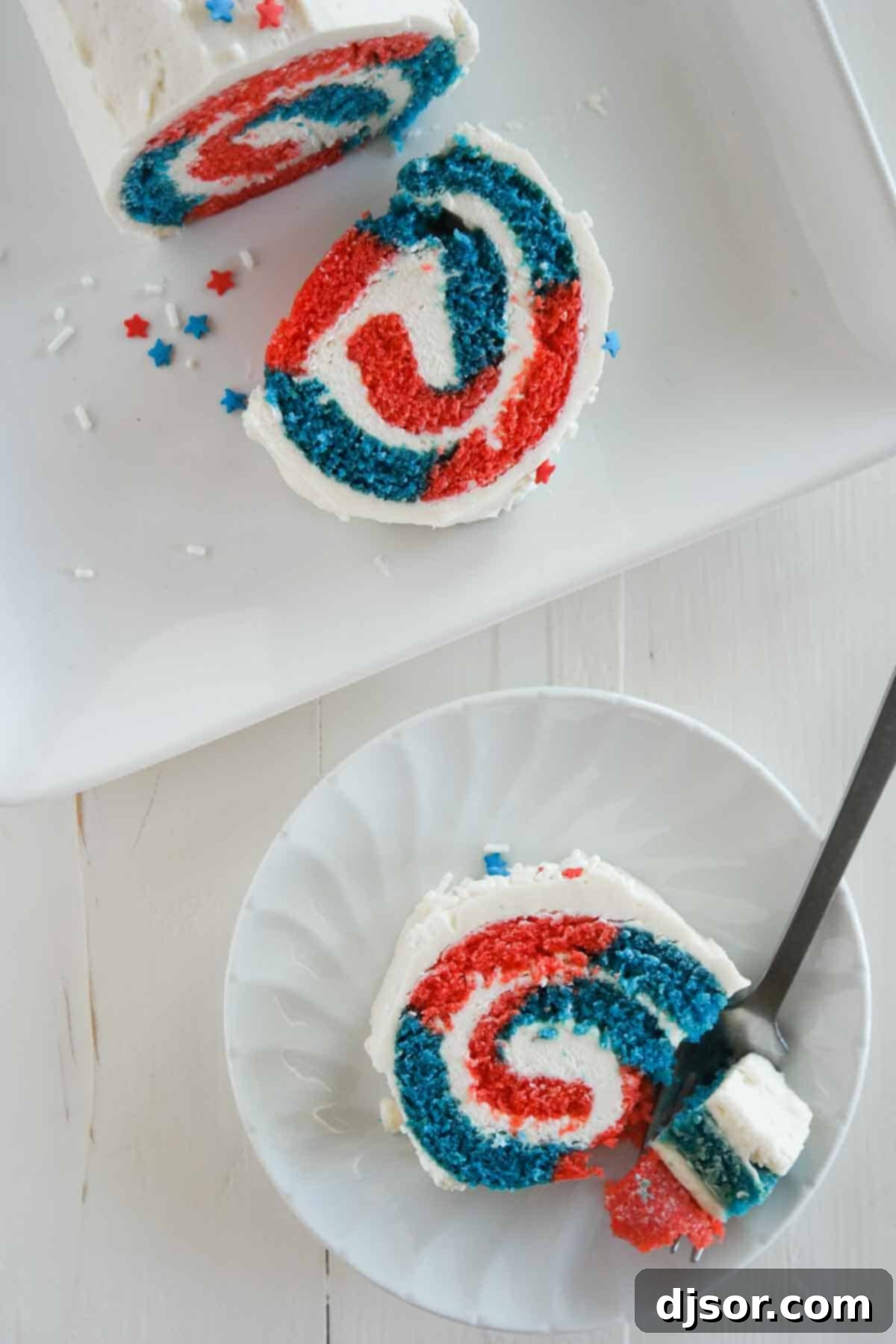 Overhead view of a beautifully decorated red, white, and blue 4th of July cake roll, ready for serving