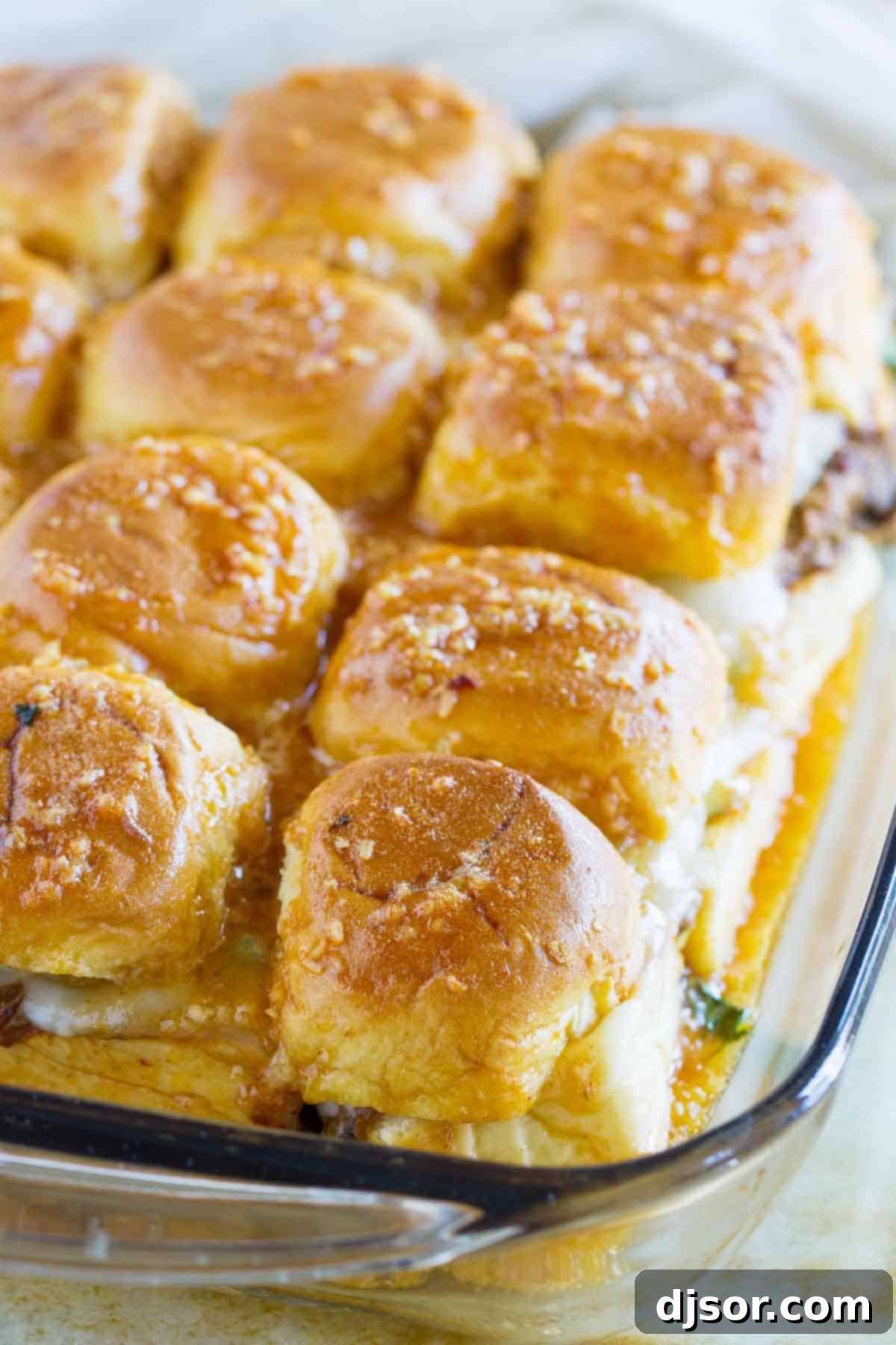 Baked Enchilada Beef Sliders in a glass baking dish, ready to be served.