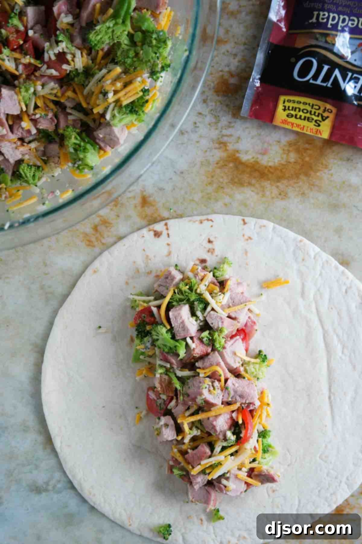 Putting filling on a tortilla for Grilled Pork Burritos