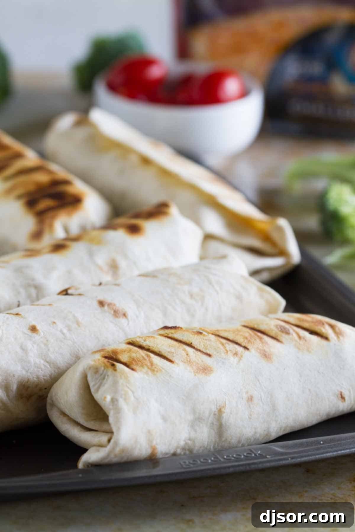 Grilled Pork Burritos resting on a baking sheet after grilling
