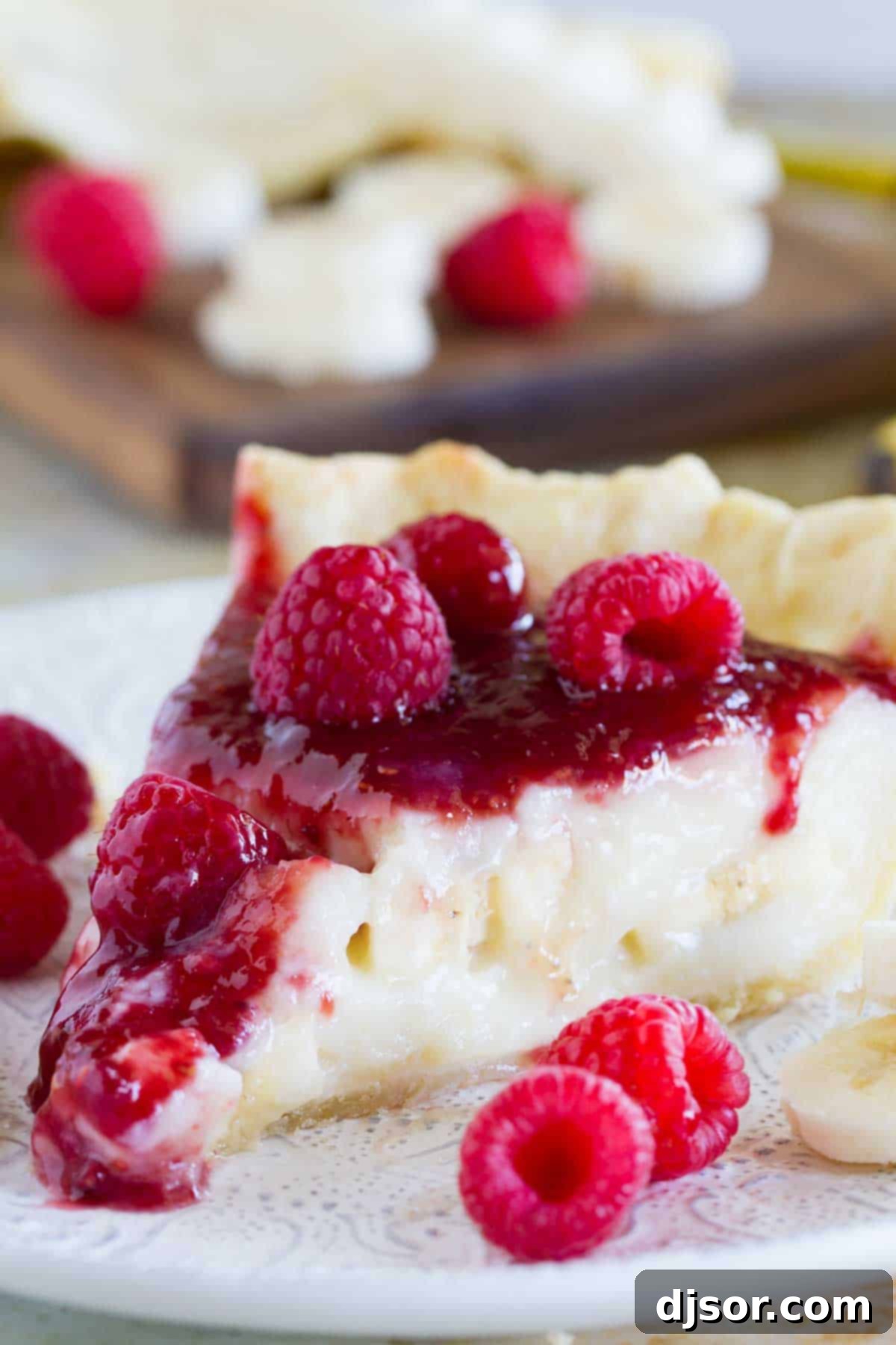 Easy Raspberry Banana Pie 3 Slice of Raspberry Banana Pie o a plate with fresh raspberries.