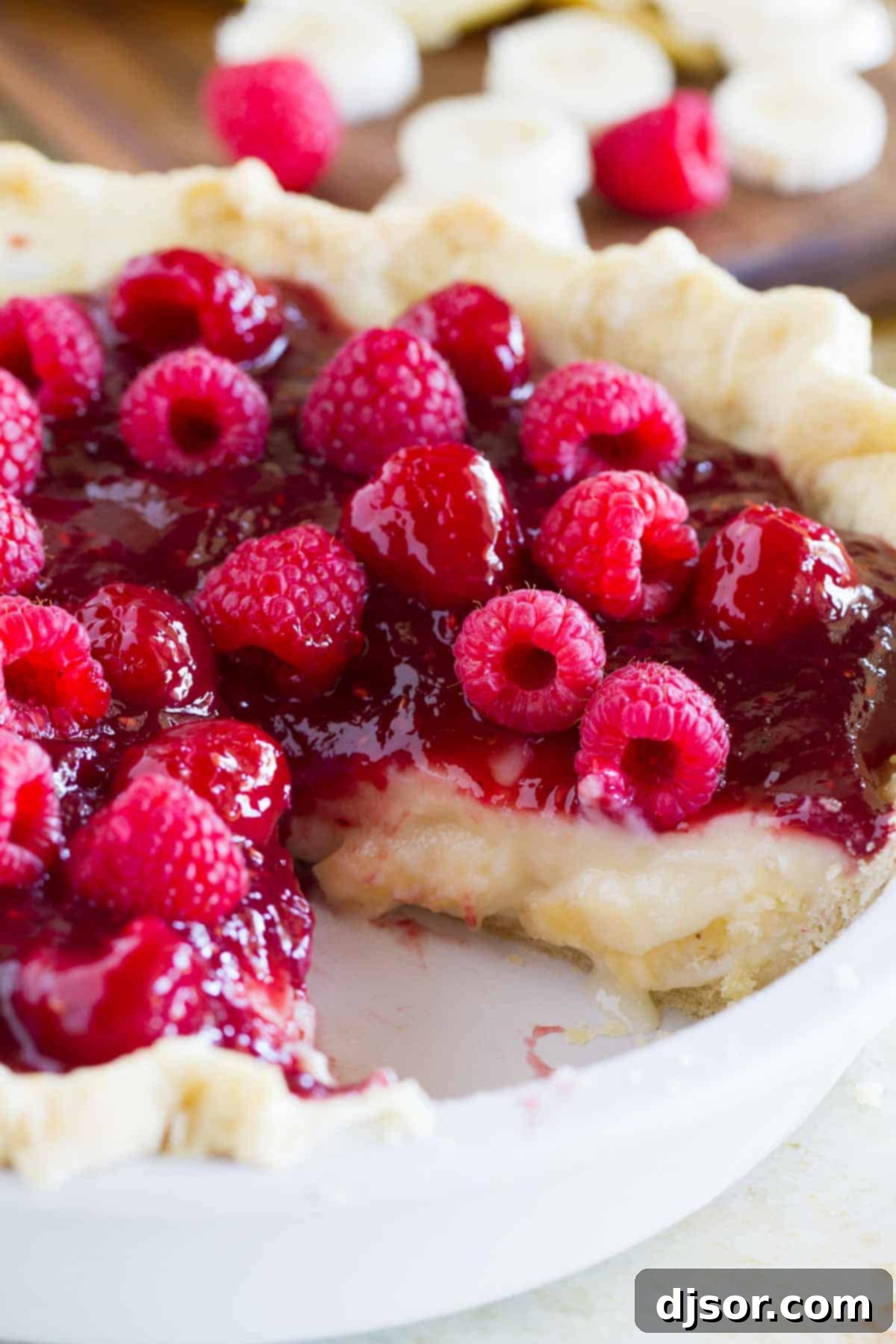 Easy Raspberry Banana Pie 4 Raspberry Banana Pie with a slice taken from it.