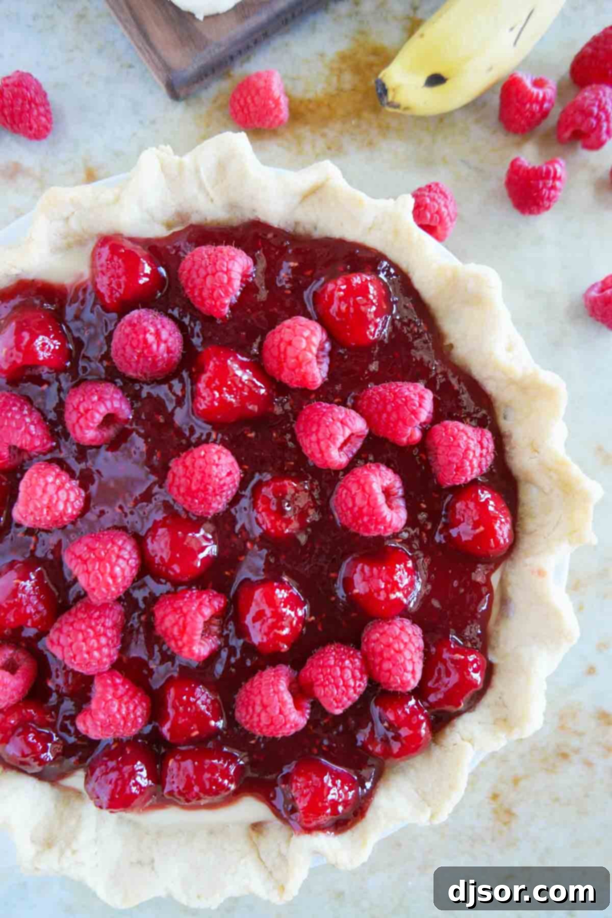 Easy Raspberry Banana Pie 5 Full Raspberry Banana Pie topped with fresh raspberries.