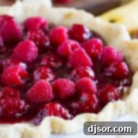 Easy Raspberry Banana Pie 6 Raspberry Banana Pie - banana cream pie topped with raspberry sauce and fresh raspberries.