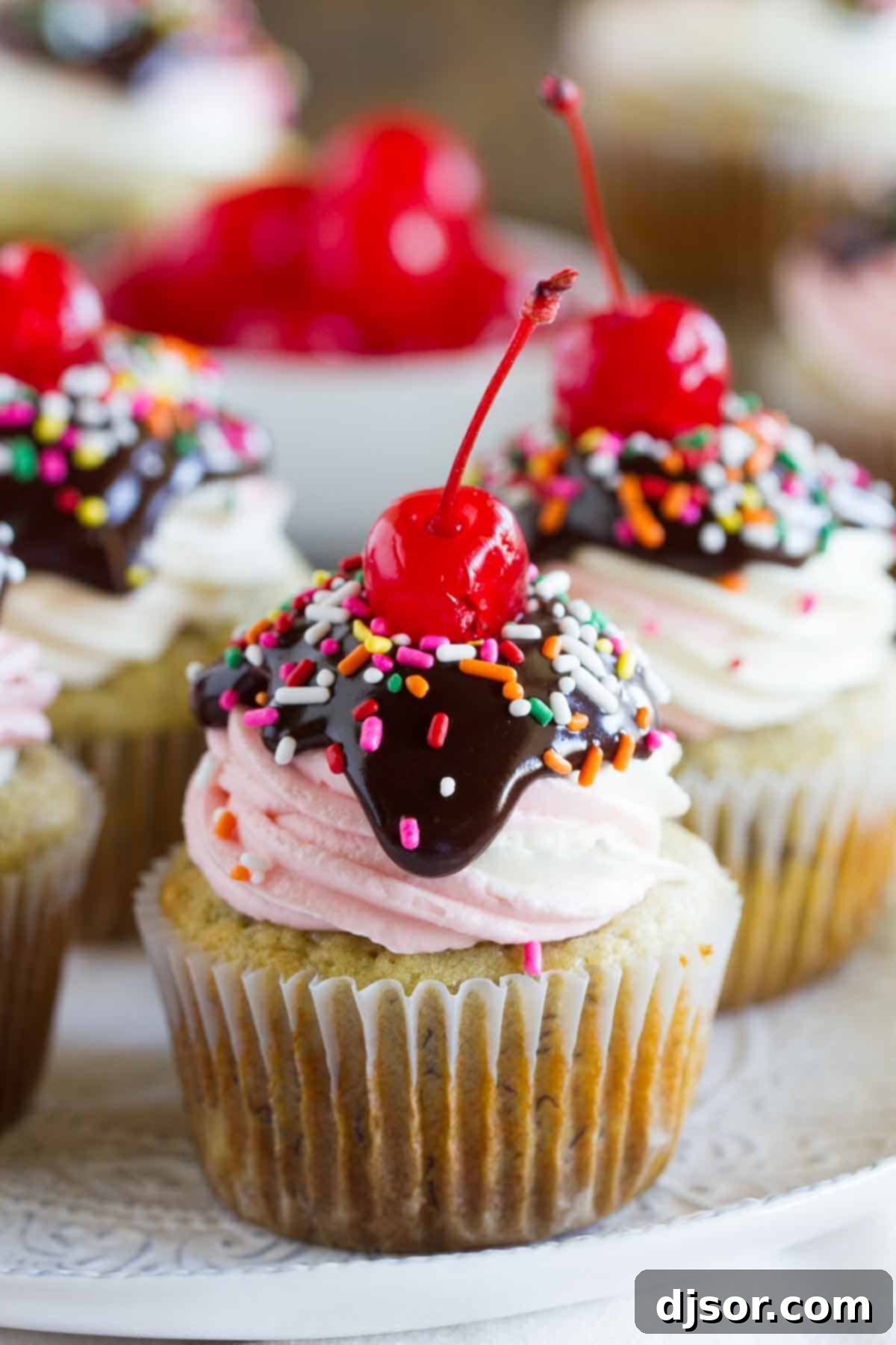 beautifully decorated banana split cupcakes arranged on a pristine white plate, showcasing their vibrant colors and tempting toppings