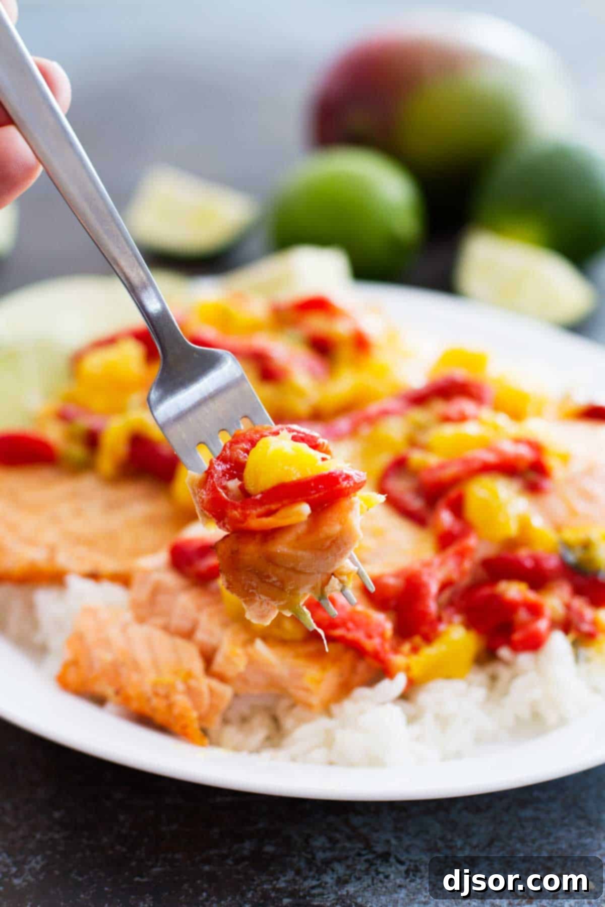 Salmon with Mango and Roasted Red Pepper: A close-up of a perfectly cooked salmon fillet with colorful, fresh salsa on top.