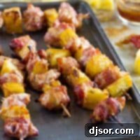 Bacon Wrapped Teriyaki Chicken Skewers on a baking sheet, ready to be cooked