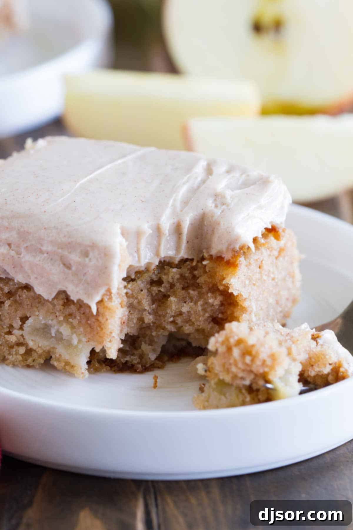 forkful of apple cinnamon sheet cake on a plate
