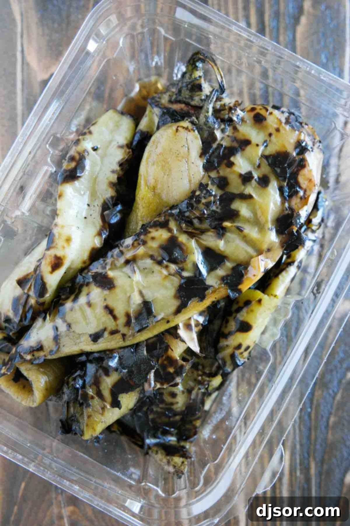 Freshly roasted Hatch green chiles, a cornerstone of New Mexican cuisine container of roasted hatch green chiles