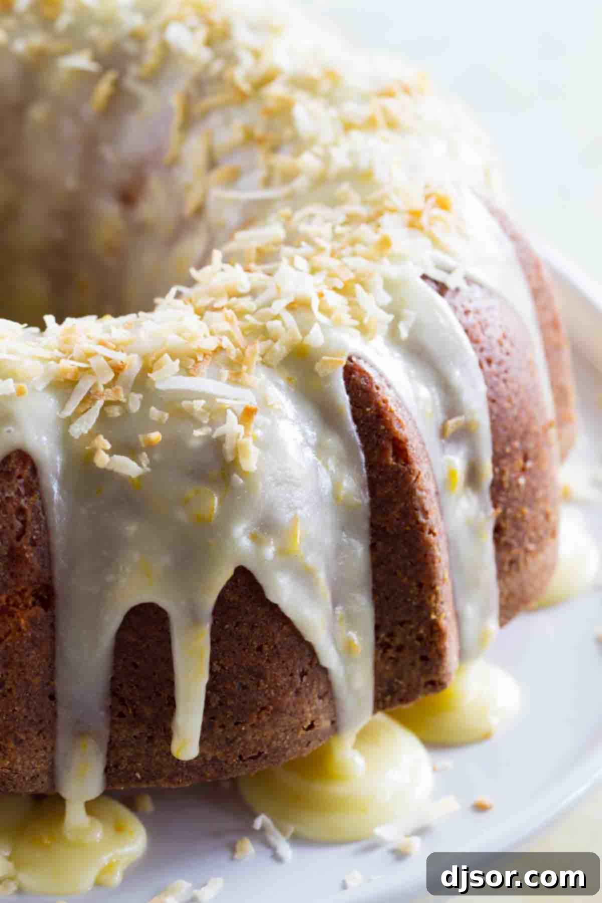 Bundt pan with coconut orange pound cake Close-up of a perfectly baked coconut orange pound cake in a fluted bundt pan, showcasing its golden-brown crust.