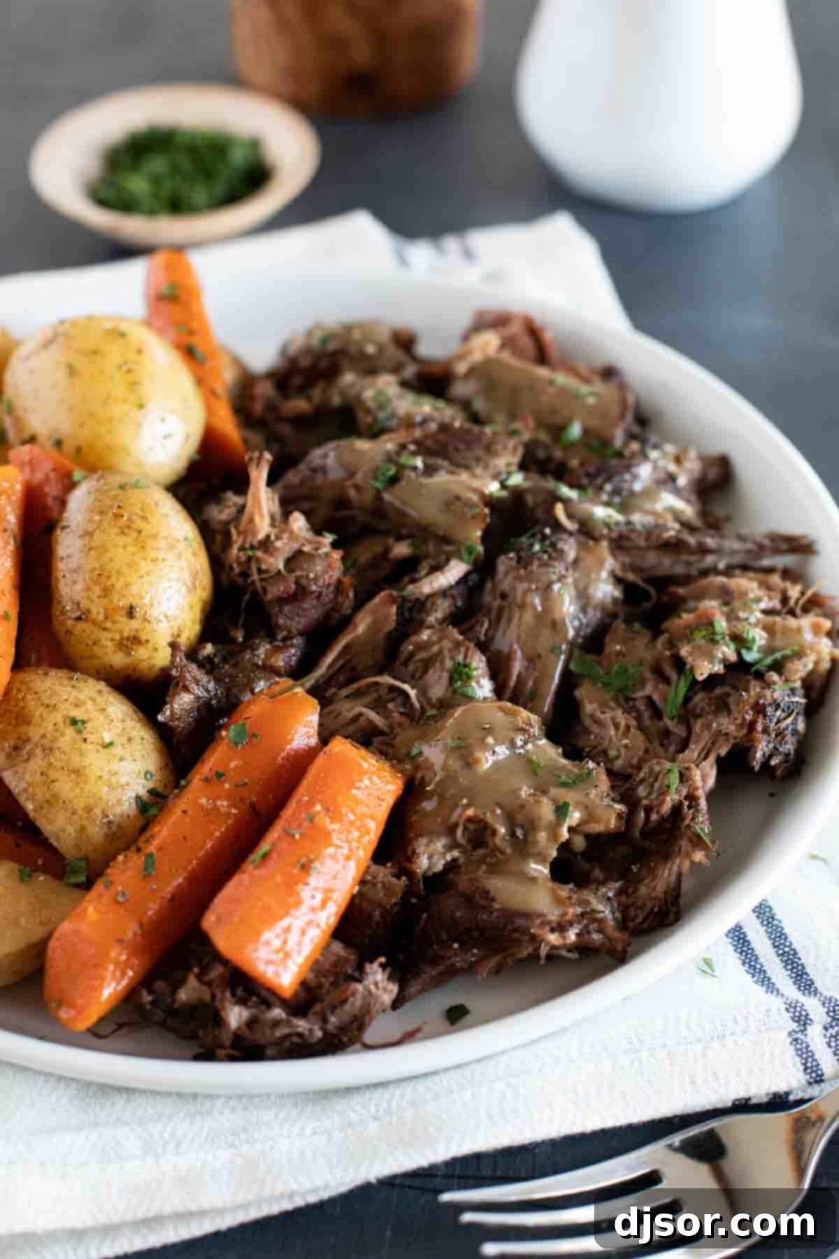 Sunday supper has never been so delicious! This Slow Cooker Pot Roast gives you perfectly tender beef, tasty (not mushy!) vegetables, and the most delicious gravy ever. pot roast made in the slow cooker with gravy on top