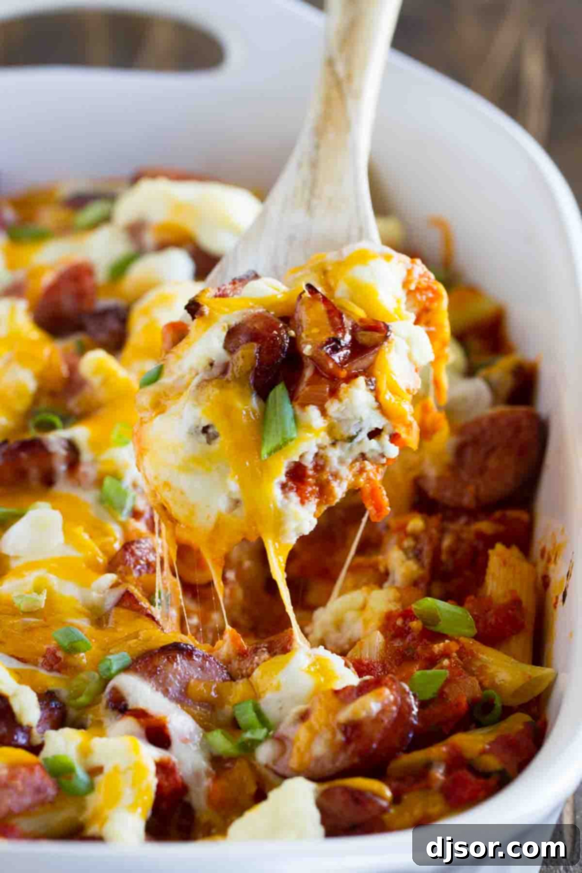 Cheesy Kielbasa Pasta: Your Go-To Freezer Meal A spoonful of rich, Cheesy Kielbasa Pasta being dished out from a casserole