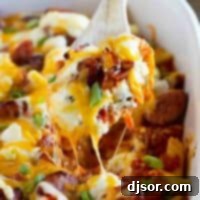 Freezer Friendly Cheesy Kielbasa Pasta 2 Dishing out a spoonful of Cheesy Kielbasa Pasta